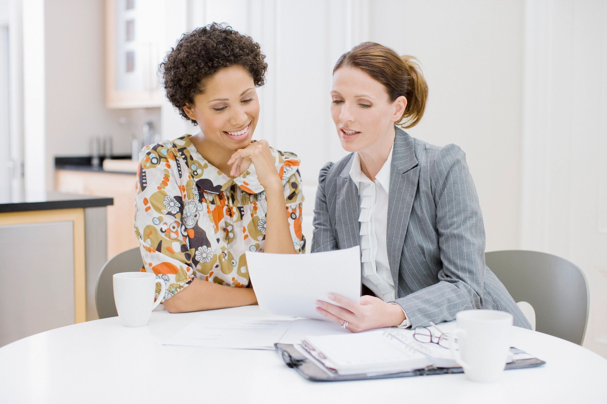 Two professionals reviewing insurance documents